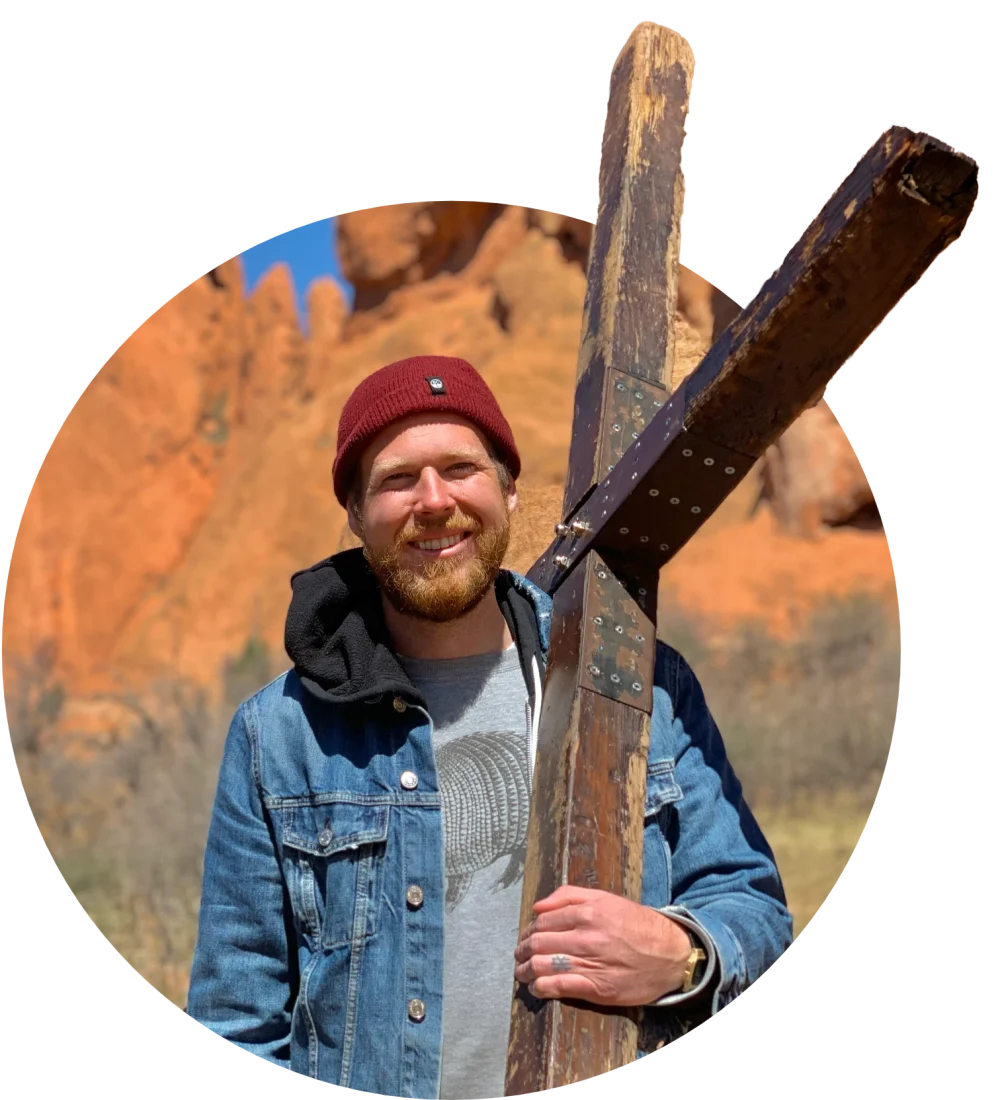 Jonathan Puckett holding a wooden cross at Garden of the Gods